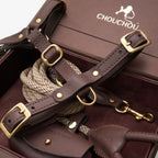 Macro close-up of the chocolate brown leather dog harness and rope leash by CacheMio & CHOUCHOÚ, highlighting brass hardware.