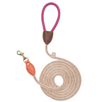 Top-down view of the vibrant Chromatique dog leash by CacheMio & CHOUCHOÚ, featuring a striking pink leather handle and orange clasp detailing.