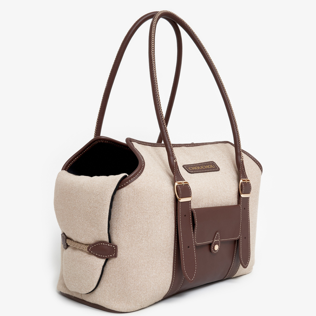 Rich brown Italian leather accents beautifully frame the soft beige textured body of this everyday designer pet carrier.