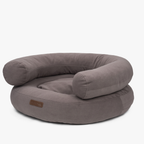 Thick supportive bolsters and velvet-touch upholstery define the deep chocolate-toned pet lounge, presented in a crisp studio stance.
