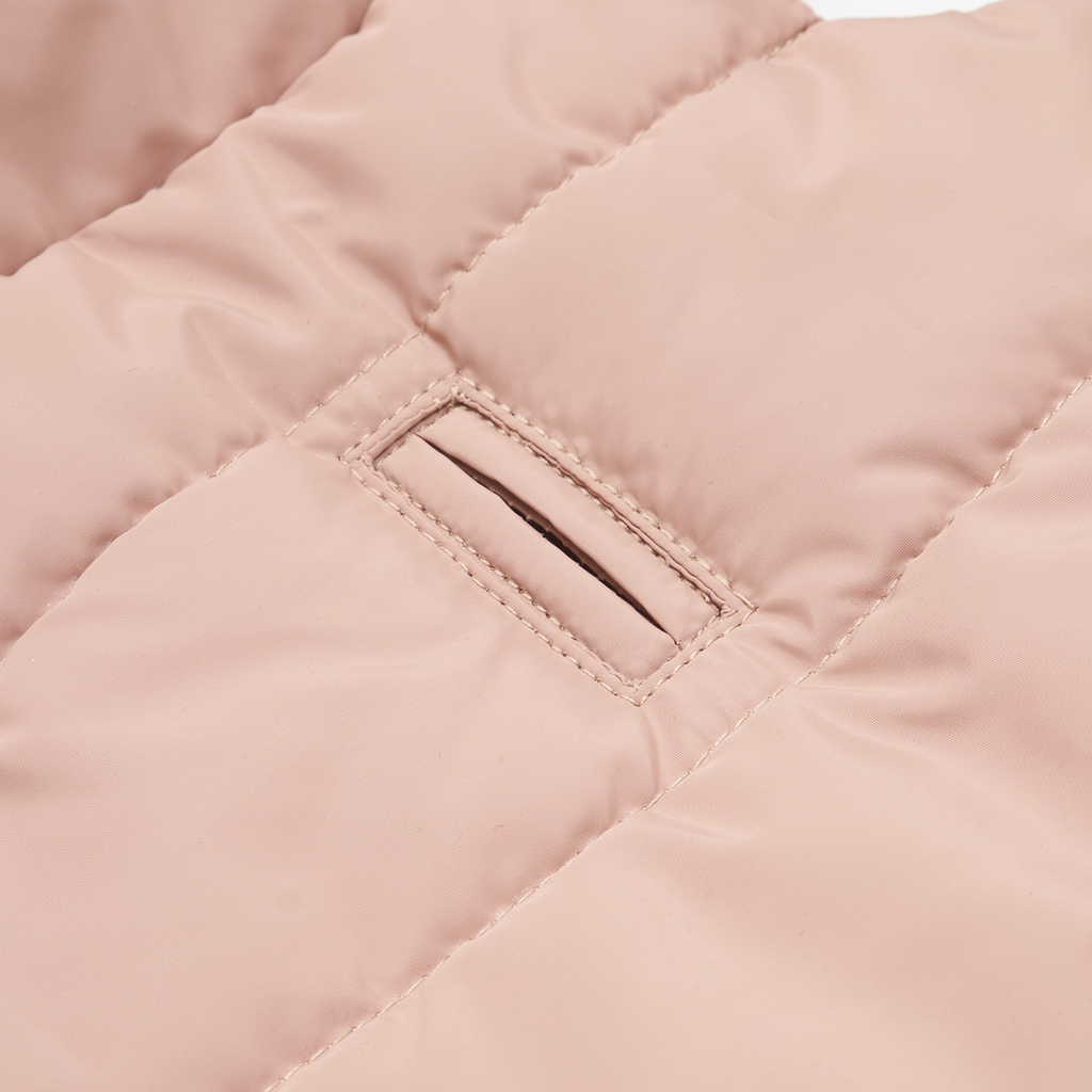 Precision tailoring is evident in the reinforced leash access point. This hidden architectural slit allows owners to attach gear to a harness worn underneath without sacrificing the jacket's waterproof integrity.