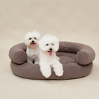 Structural stability is demonstrated as two fluffy white companions stand and rest confidently along the thick borders of the brown resting space.