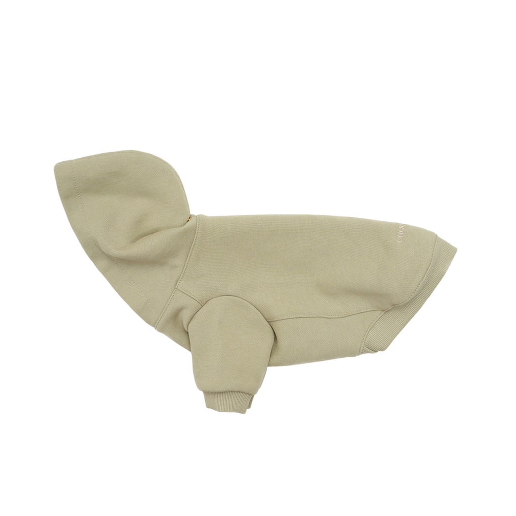 Lateral perspective emphasizes the ergonomic sleeve angle and thick ribbed cuffs of the heavyweight cotton dog hoodie in a calming sage tone.