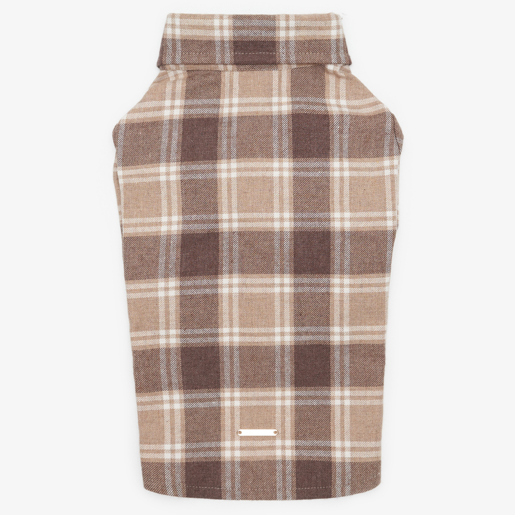 Back view of a brown checkered pet shirt laid flat, featuring a seamless tartan pattern and a small metal logo plate at the bottom hem.