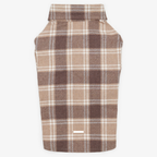 Back view of a brown checkered pet shirt laid flat, featuring a seamless tartan pattern and a small metal logo plate at the bottom hem.