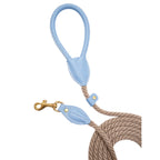 Macro detail of the premium light blue leather handle and rust-resistant brass hardware on the CacheMio & CHOUCHOÚ dog leash.