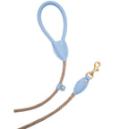 Pastel light blue leather dog leash handle and solid brass clasp by CacheMio & CHOUCHOÚ, connected by a durable beige rope.