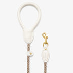 Clean aesthetic flatlay of the premium Milk White dog leash by CacheMio & CHOUCHOÚ, highlighting the minimalist design and rust-resistant brass hardware.