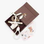 Top-down view of the luxurious milk white leather dog walking set by CacheMio & CHOUCHOÚ, beautifully presented in a magnetic gift box with care cards.