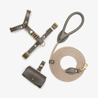 Minimalist flatlay of the complete Olive green leather dog walking set by CacheMio & CHOUCHOÚ, featuring a premium harness, rope leash, and bag dispenser.