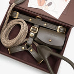 Close-up of the Olive green premium Italian leather dog harness and waste bag holder by CacheMio & CHOUCHOÚ, resting elegantly inside the signature packaging.