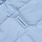 Precision stitching frames the reinforced harness portal cut into the waterproof textile. This architectural detail allows seamless lead attachment without compromising the thermal integrity of the coat.