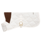 Crisp winter-white pet apparel rests in a lateral stance, emphasizing its structured defense against the elements. The stark contrast between the bright shell and dark velvet neckpiece creates an immediately striking visual profile.