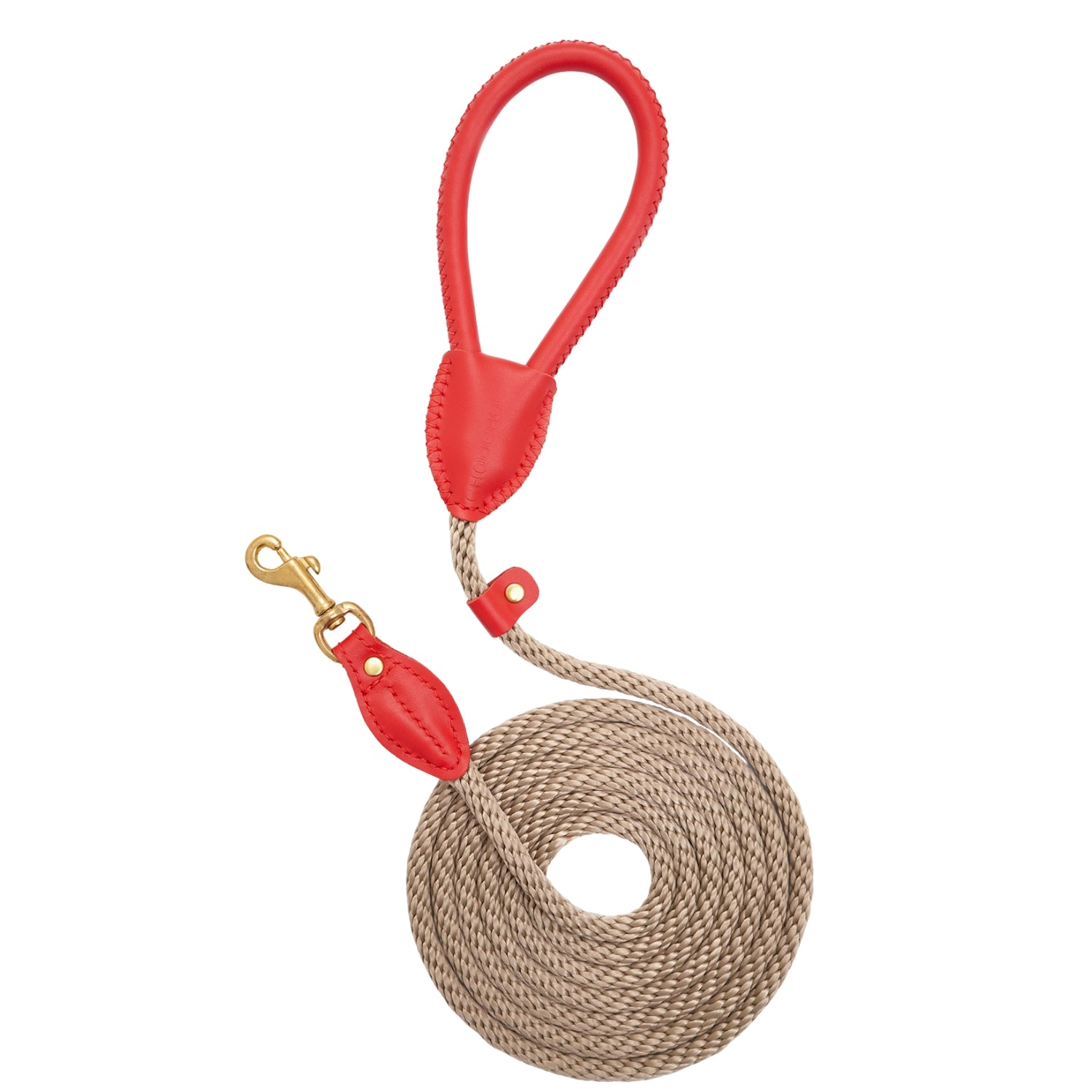 Top-down view of the coiled Classic Red walking leash by CacheMio & CHOUCHOÚ, featuring a bold red leather handle and earthly beige rope.