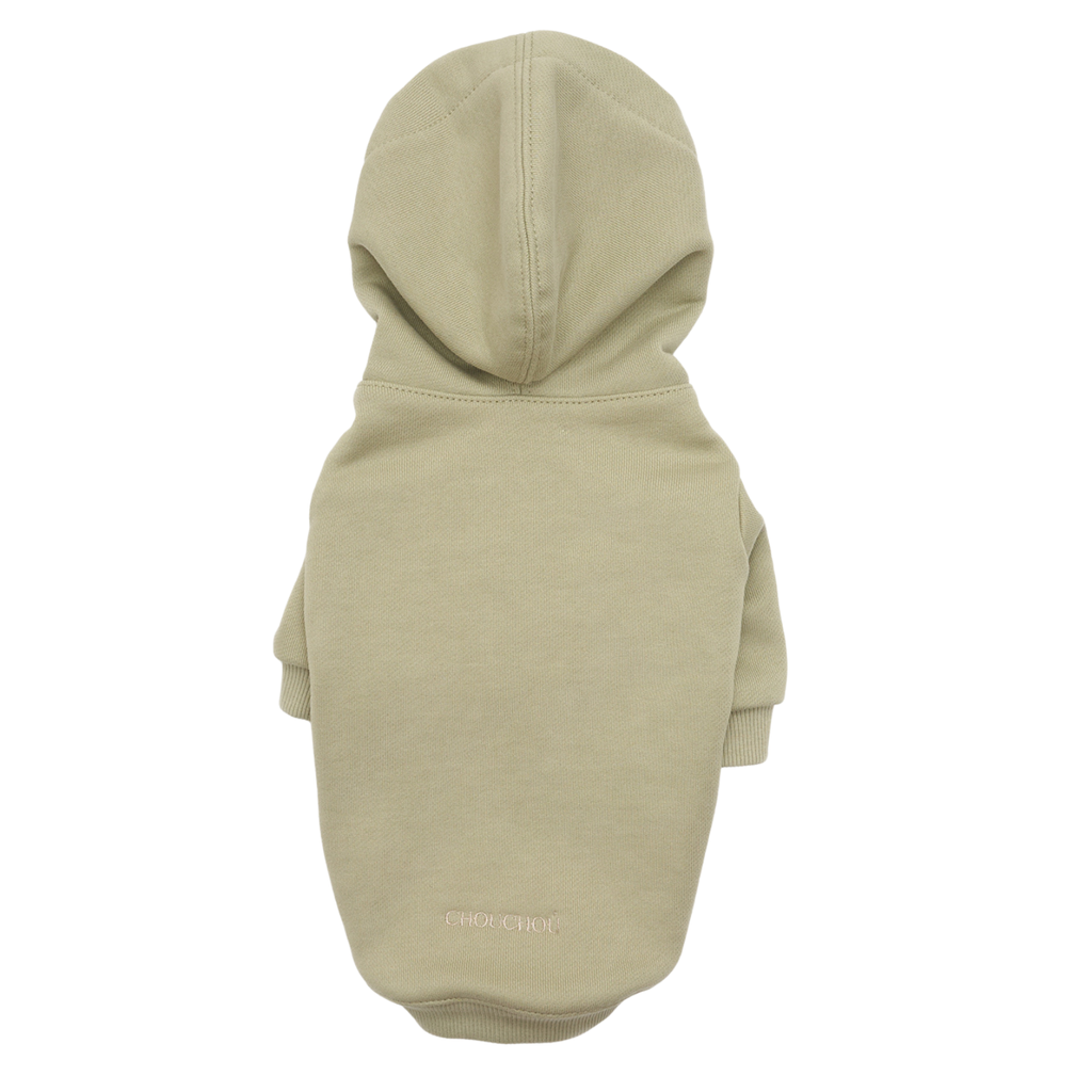 Seamless dorsal construction of the light green pet sweater, featuring the minimalist CHOUCHOÚ embroidery and a functional draft-proof hood.