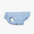 Crisp lines define the sky-blue winter garment as it rests in a structured lateral pose. The aerodynamic cut ensures maximum chest protection while maintaining an effortlessly chic aesthetic for small breeds.