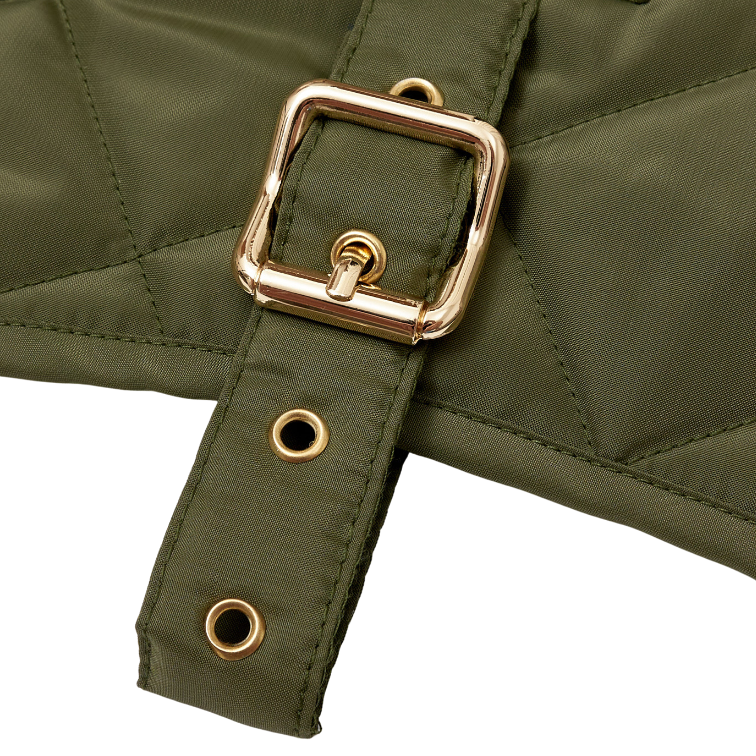 Macro detail of the rust-resistant solid brass buckle and meticulous stitching on the CacheMio x CHOUCHOÚ olive weather-resistant belt.