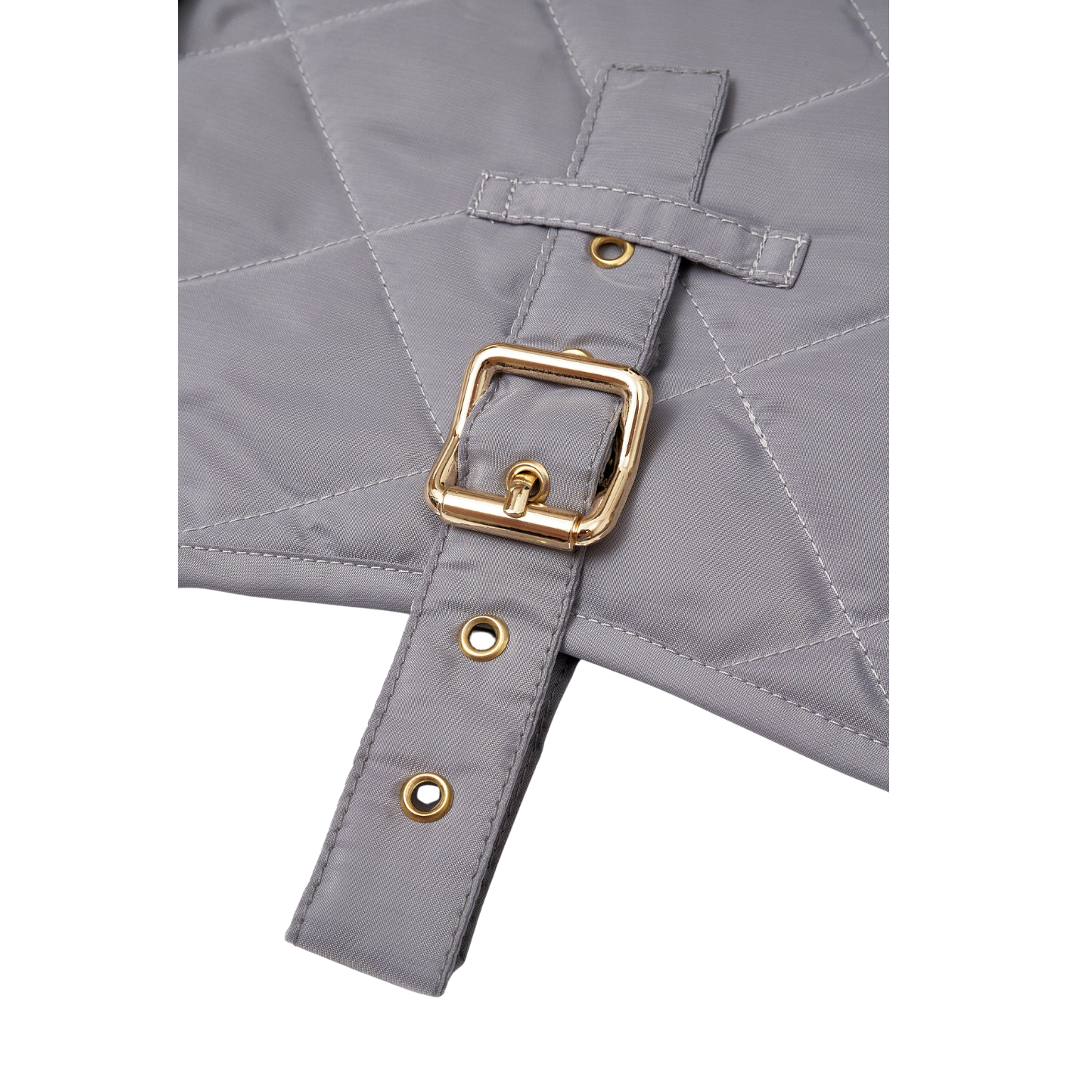 Extreme close-up of the heavy-duty solid brass hardware and meticulous stitching on the CacheMio x CHOUCHOÚ weather-ready dog apparel.
