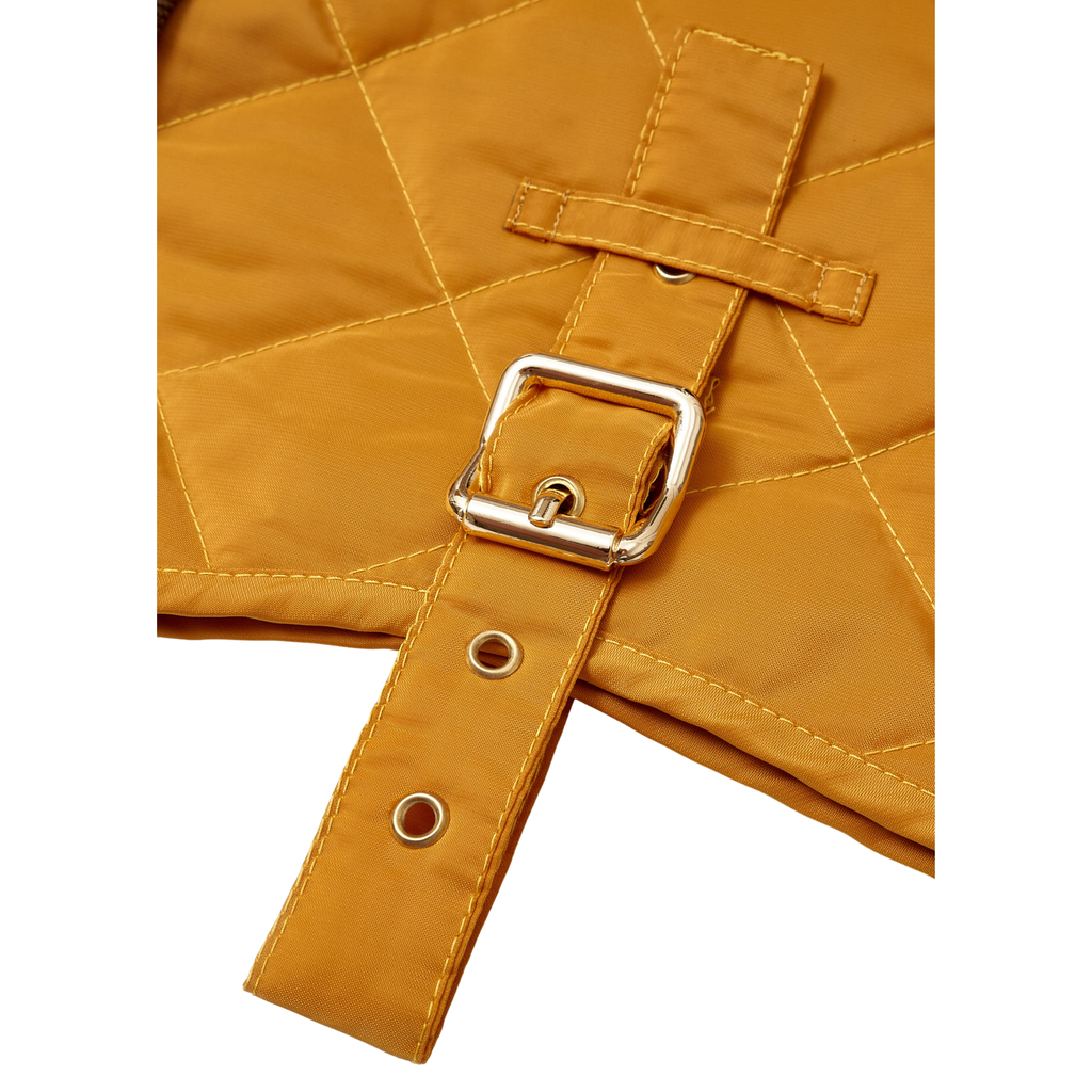 Golden-tone brass hardware securely fastened across a rich yellow water-resistant textile, ensuring absolute durability during active daily walks.
