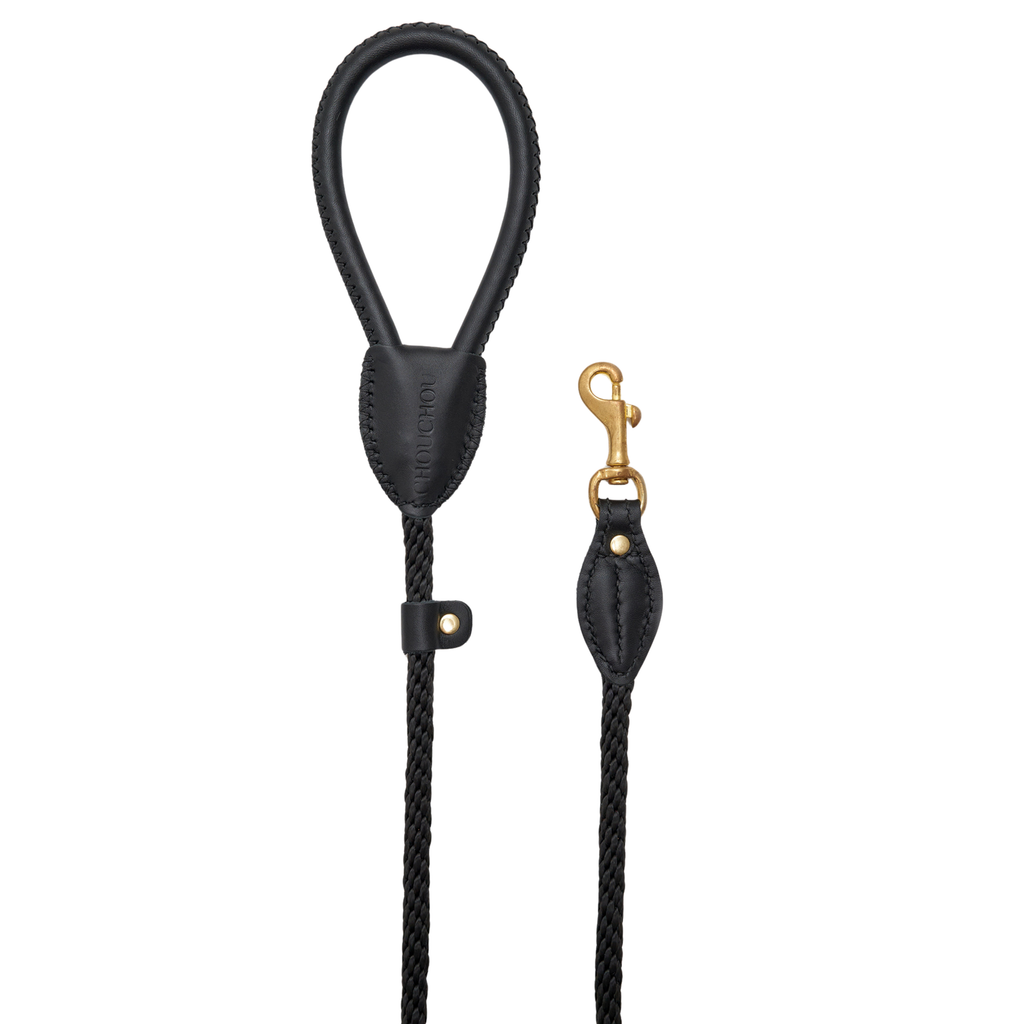 Minimalist vertical display of the elegant black Italian leather dog leash, emphasizing the seamless transition into the heavy-duty rope.