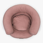Top-down view of the pink Marshmallow luxury dog bed by CHOUCHOÚ, showcasing its cozy contoured shape and hypoallergenic resting area.