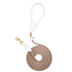 Top-down view of the coiled Classic Red walking leash by CacheMio & CHOUCHOÚ, featuring a bold milk-white leather handle and earthly beige rope.