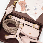 Unboxing the CHOÚ pale pink leather dog accessories set, featuring the harness, leash, dispenser, and elegantly illustrated care cards.